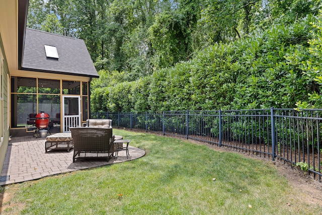 view of yard featuring a sunroom and a patio area