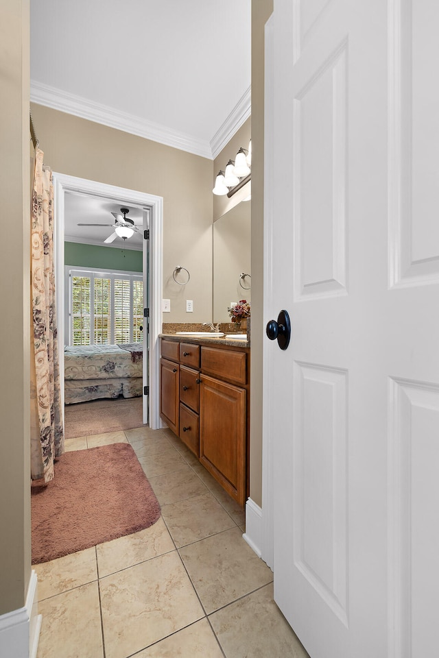 bathroom featuring tile patterned flooring, vanity, ceiling fan, and ornamental molding