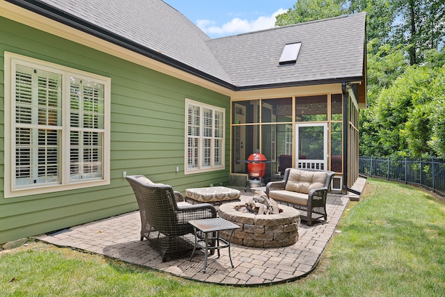 view of patio / terrace featuring a sunroom and an outdoor fire pit