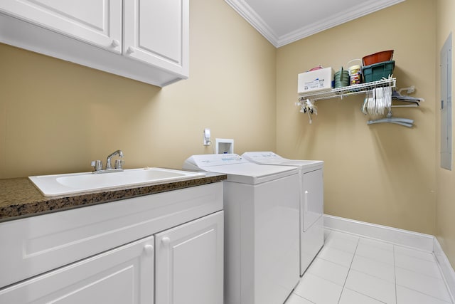 laundry room featuring cabinets, ornamental molding, sink, light tile patterned floors, and washing machine and clothes dryer