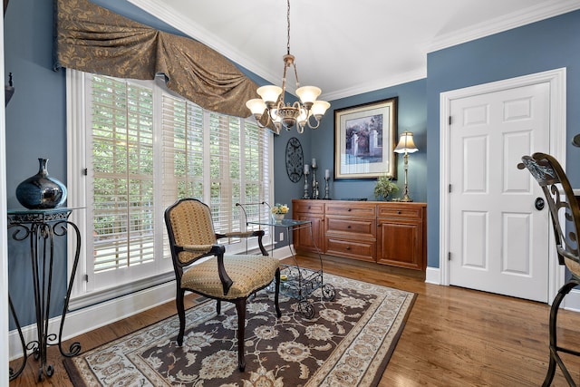 living area featuring ornamental molding, a notable chandelier, and hardwood / wood-style flooring