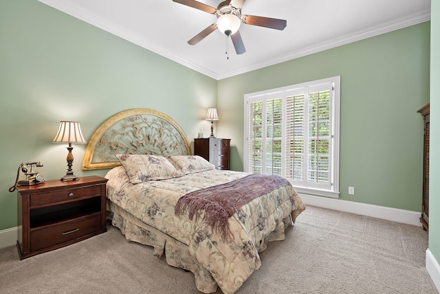 carpeted bedroom with ceiling fan and ornamental molding