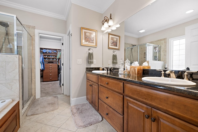 bathroom featuring vanity, a shower with door, and crown molding