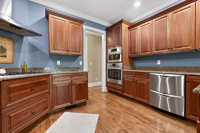 kitchen with stainless steel appliances, light hardwood / wood-style flooring, wall chimney exhaust hood, and crown molding