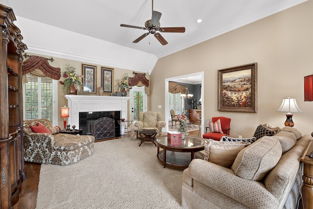 living room with crown molding, ceiling fan with notable chandelier, lofted ceiling, and hardwood / wood-style flooring