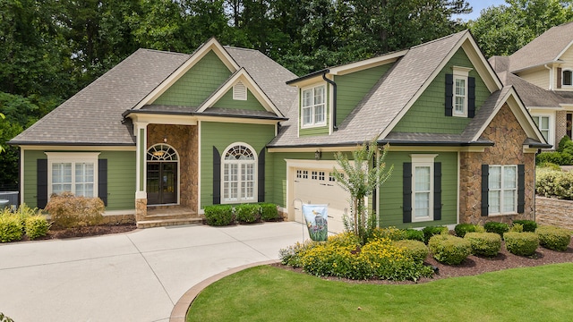 craftsman-style house with a garage and a front lawn