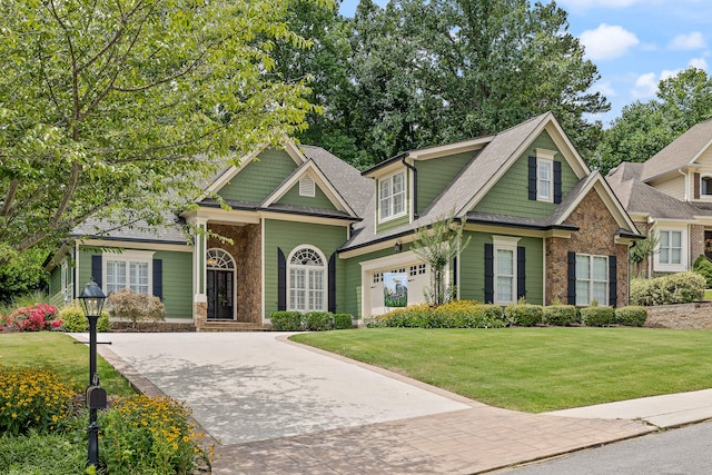 craftsman-style home featuring a garage and a front lawn