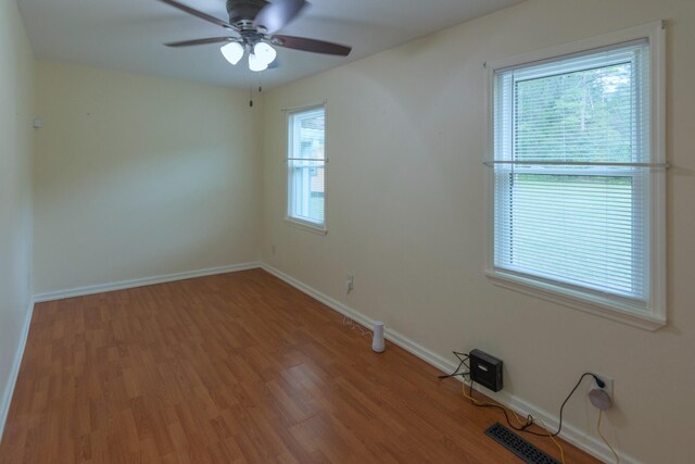 empty room featuring ceiling fan and hardwood / wood-style flooring