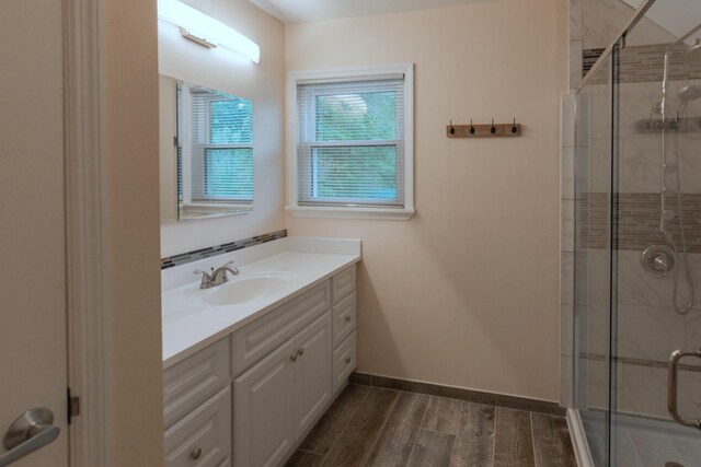 bathroom featuring vanity, an enclosed shower, and hardwood / wood-style flooring