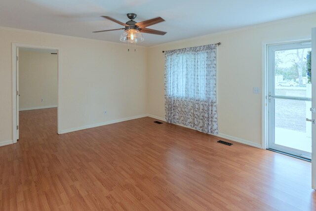 empty room with ceiling fan, light hardwood / wood-style floors, and ornamental molding