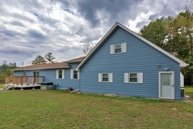 back of property featuring a deck, a yard, and central air condition unit