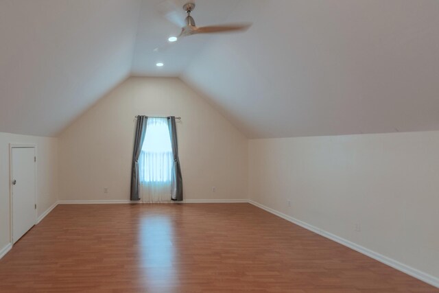 bonus room featuring light wood-type flooring, vaulted ceiling, and ceiling fan