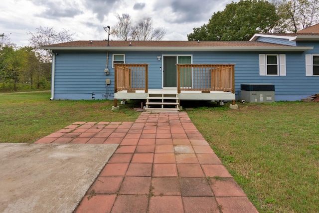 back of property featuring a yard, a patio, central AC unit, and a deck