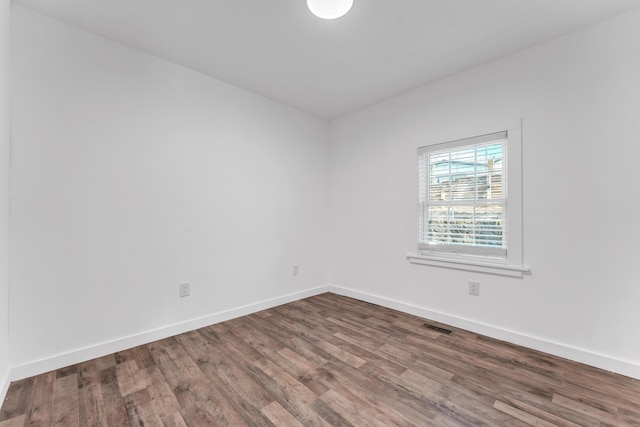 unfurnished room with wood-type flooring