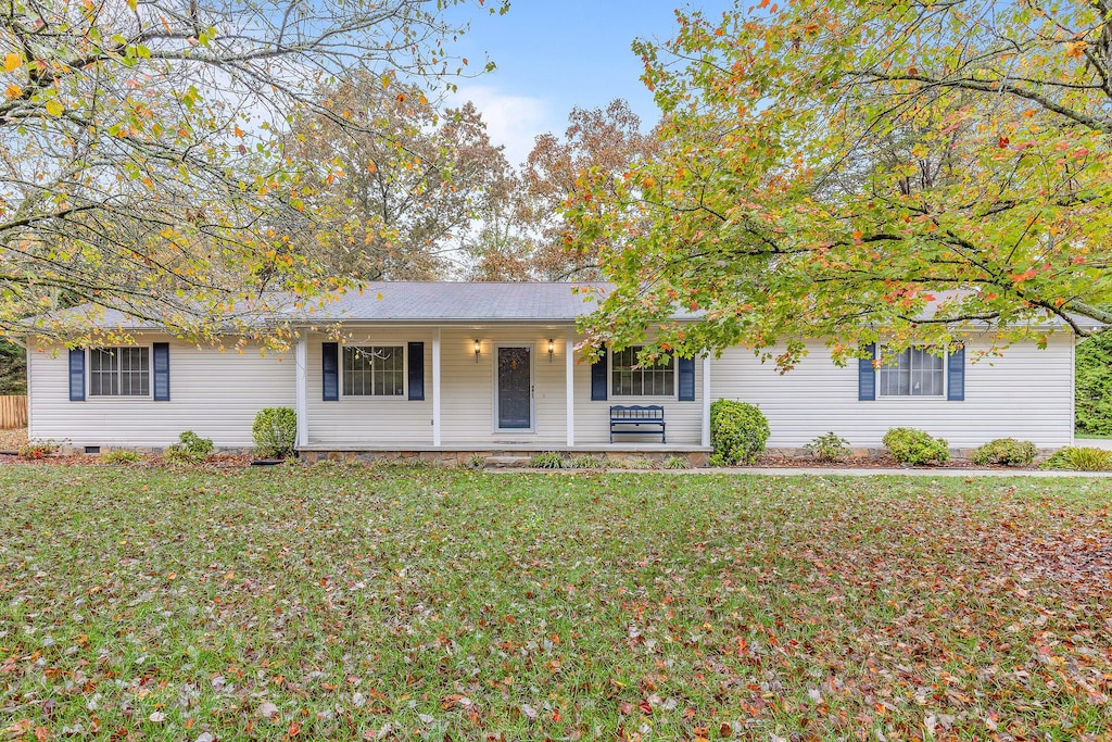 view of front of house with a front yard and a porch