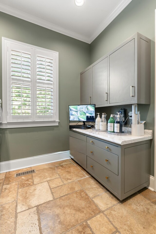 715 Pembridge Cir NW, Cleveland, TN 37312 - kitchen with gray cabinets, ornamental molding, stone tile floors, and light stone counters