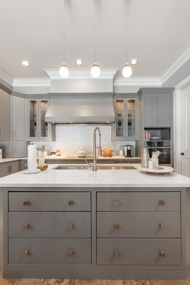 715 Pembridge Cir NW, Cleveland, TN 37312 - kitchen with gray cabinets, ornamental molding, custom exhaust hood, light countertops, and backsplash