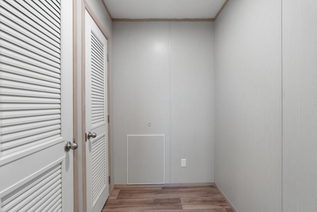 hall with crown molding and light hardwood / wood-style flooring