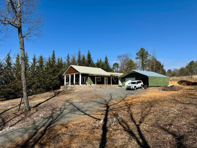 ranch-style home featuring covered porch and a carport