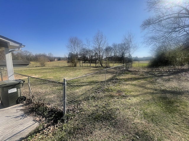 view of yard with a rural view and fence