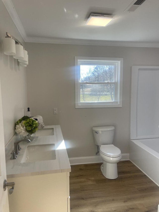 full bathroom with toilet, wood finished floors, visible vents, and a sink