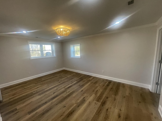 unfurnished room featuring crown molding, baseboards, and dark wood-style flooring