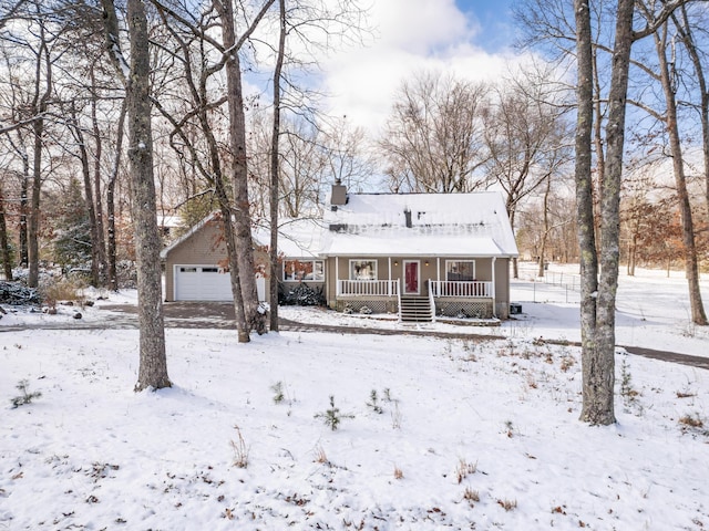 view of front of property featuring covered porch, a chimney, and a garage