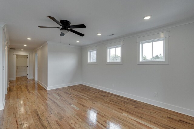 spare room featuring ceiling fan, crown molding, and light hardwood / wood-style flooring