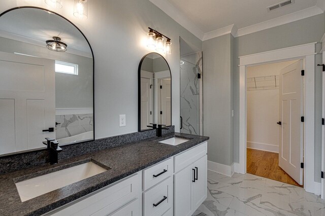 bathroom featuring hardwood / wood-style floors, vanity, and ornamental molding