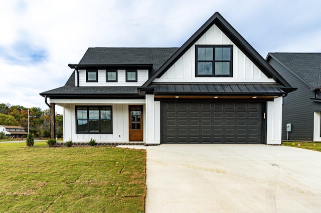 modern farmhouse featuring a front yard and a garage