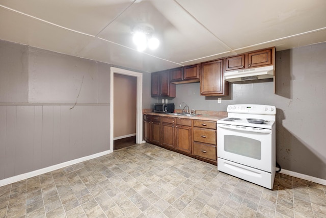 kitchen featuring sink, wooden walls, and white range with electric cooktop