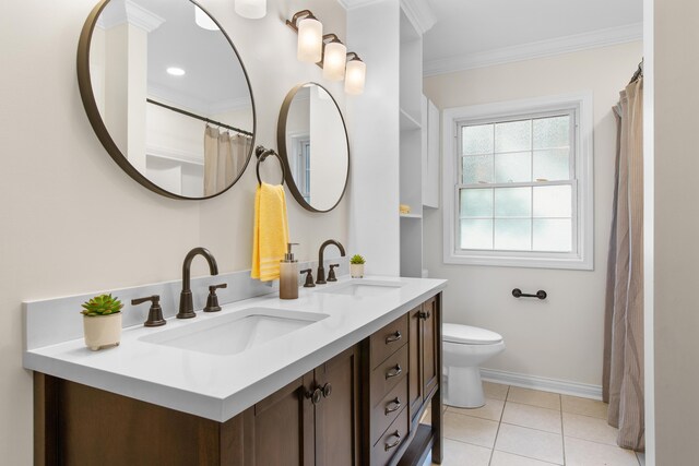 7000 Davis Ferry Rd, Loudon, TN 37774 - bathroom with crown molding, double vanity, toilet, baseboards, and tile patterned flooring