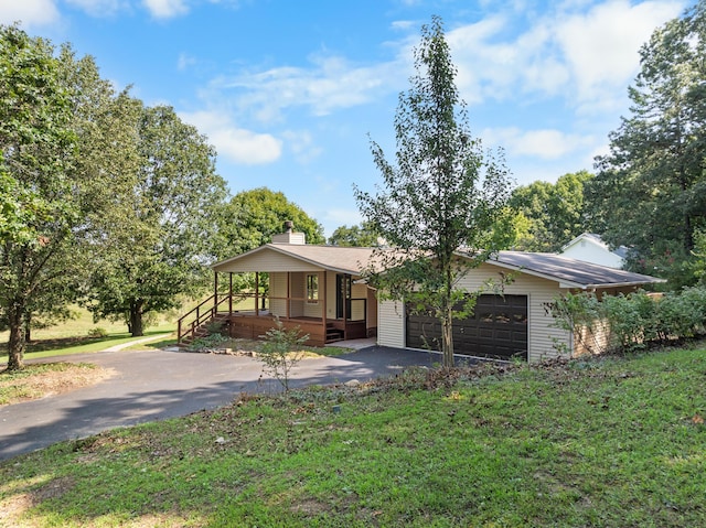 7000 Davis Ferry Rd, Loudon, TN 37774 - view of front of house featuring covered porch, driveway, a chimney, a garage, and a front lawn