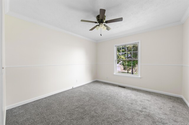 spare room with ceiling fan, crown molding, carpet floors, and a textured ceiling