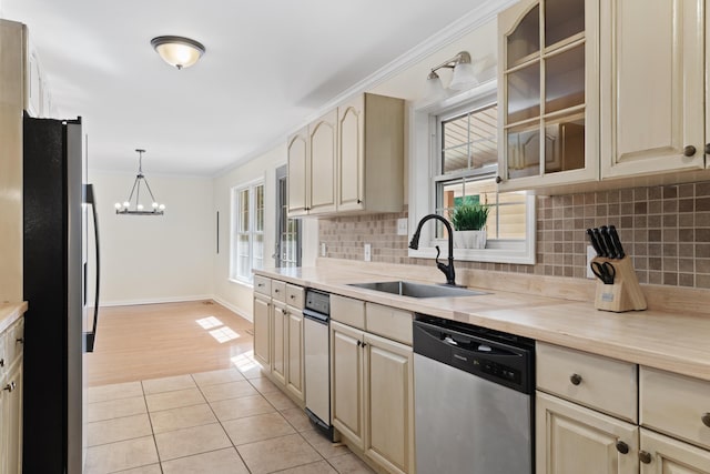 kitchen featuring decorative light fixtures, stainless steel appliances, plenty of natural light, and sink