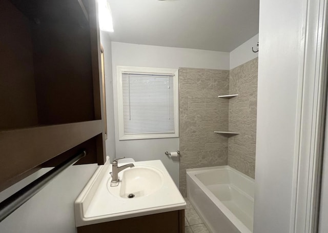 bathroom featuring tile patterned floors, vanity, and tiled shower / bath combo