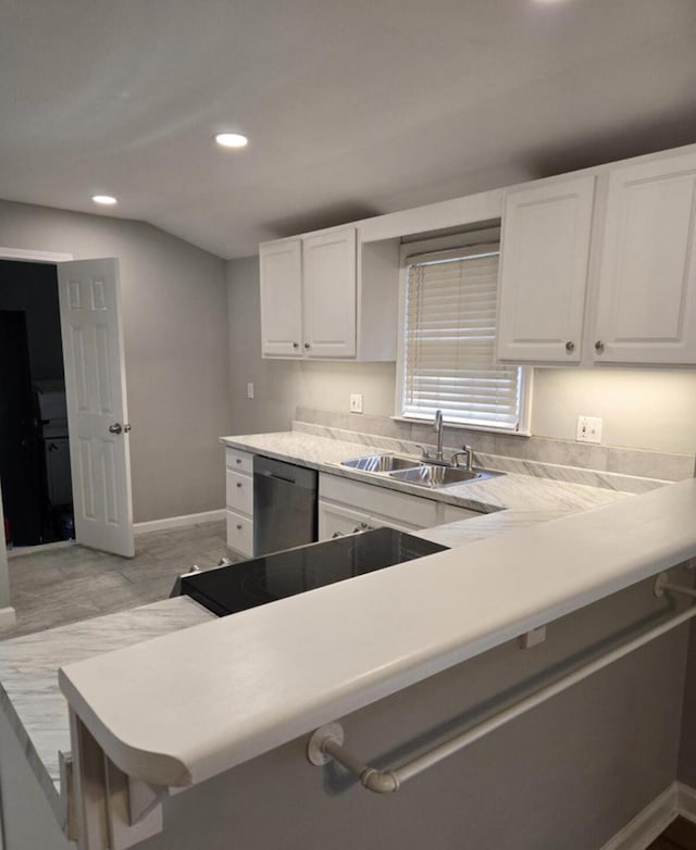 kitchen with dishwasher, a breakfast bar, white cabinets, sink, and kitchen peninsula