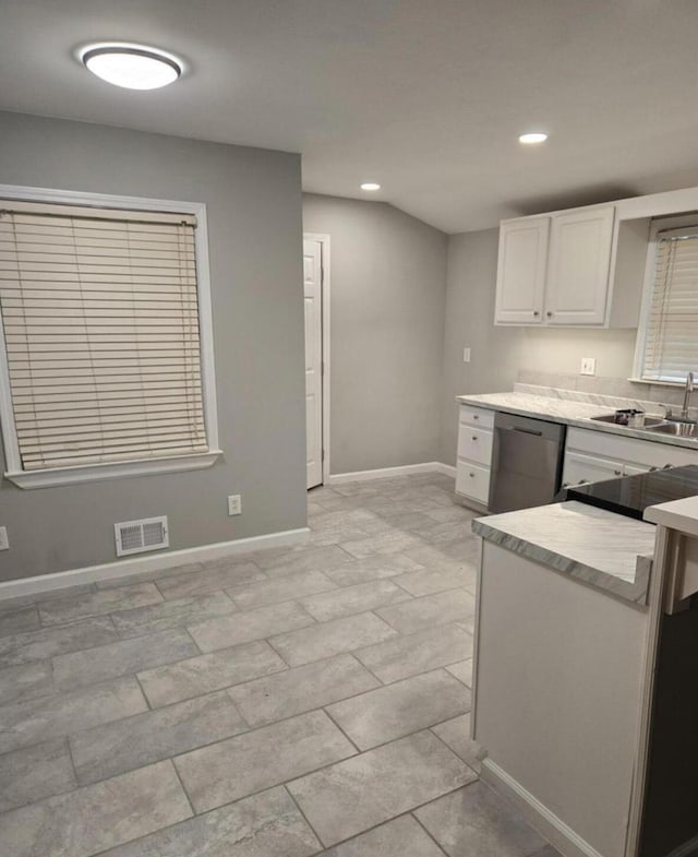 kitchen featuring stainless steel dishwasher, white cabinets, and sink