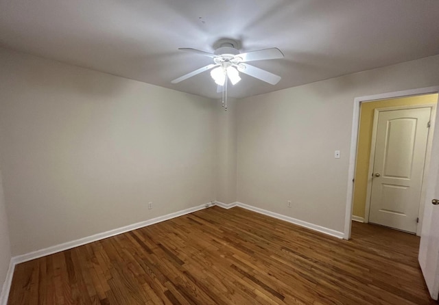 unfurnished room with ceiling fan and dark hardwood / wood-style flooring