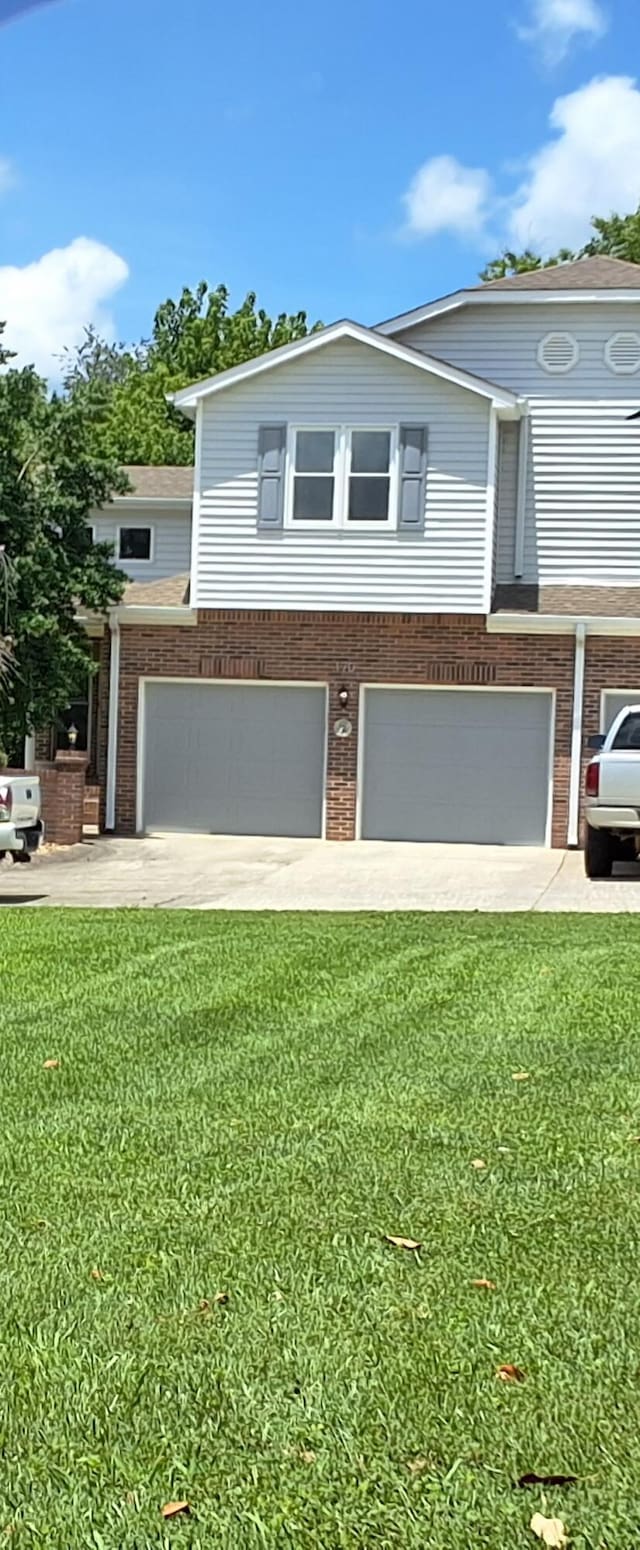 170 Courtyard Ln NE, Cleveland, TN 37312 - view of front of property with an attached garage, brick siding, a front lawn, and concrete driveway