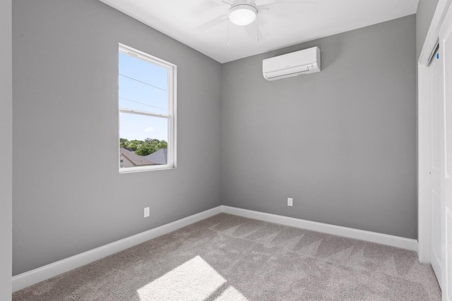 empty room with ceiling fan, carpet floors, and a wall unit AC