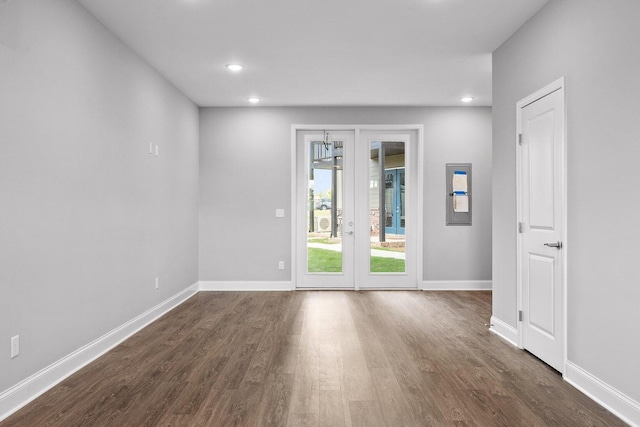 empty room with dark hardwood / wood-style flooring and french doors