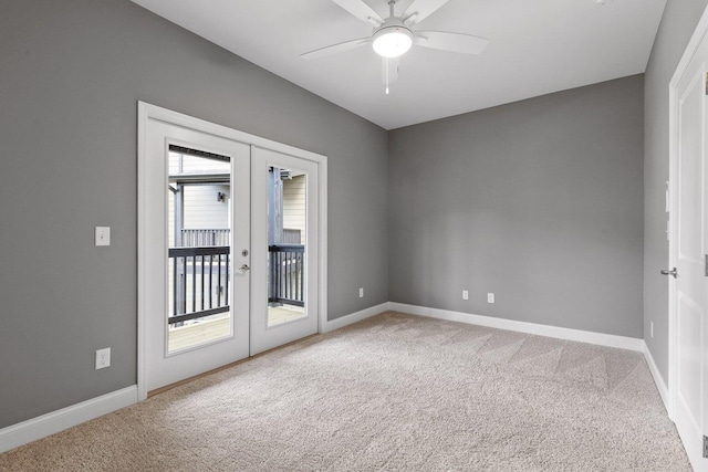 carpeted spare room with french doors and ceiling fan