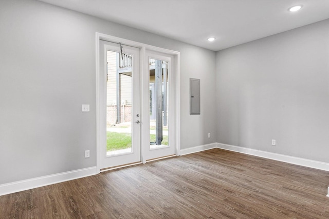 doorway to outside featuring electric panel and dark hardwood / wood-style floors