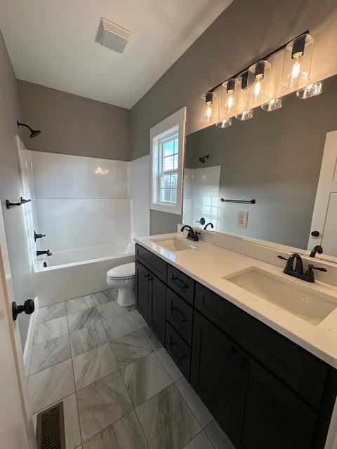 full bathroom with vanity, bathtub / shower combination, and toilet