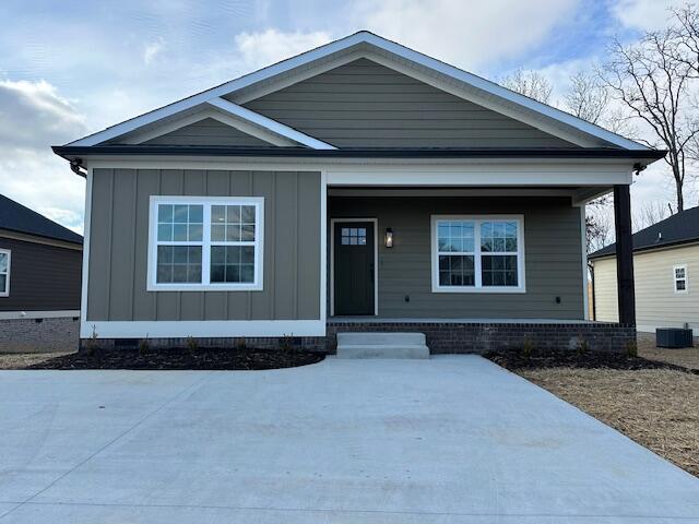 view of front of property with covered porch and central AC unit