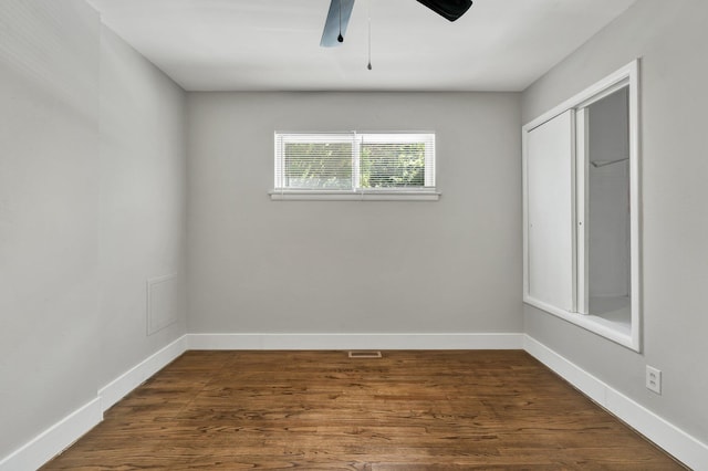 spare room featuring ceiling fan and dark hardwood / wood-style flooring