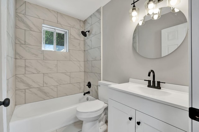 full bathroom with toilet, vanity, and tiled shower / bath