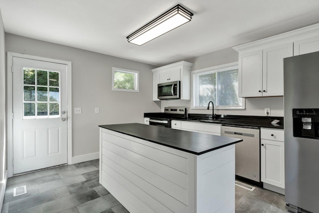 kitchen with white cabinetry, plenty of natural light, stainless steel appliances, and sink