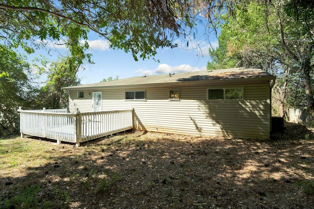 back of property featuring a wooden deck